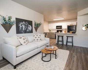 Oklahoma City apartment for rent - A living room with a white couch and a coffee table.