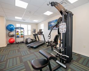 Oklahoma City apartment for rent - A gym with a treadmill, exercise ball, and other equipment.