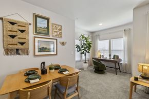 Owasso townhouse for rent - A dining room with a wooden table set for four.