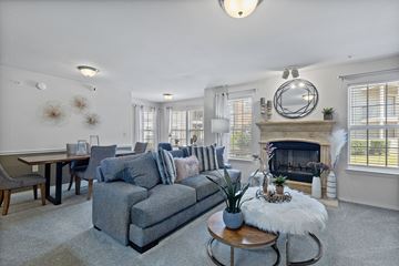 Edmond apartment for rent - A living room with a grey couch and a fireplace.