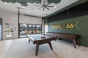 Yukon townhouse for rent - A pool table in a room with a green wall and a sign that says "RIDGE AT 66".