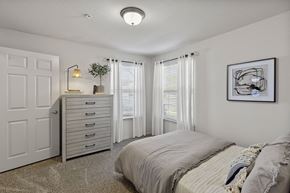Amarillo apartment for rent - A bedroom with a bed, dresser, and window with curtains.