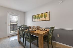 Oklahoma City apartment for rent - A dining room with a wooden table and chairs.