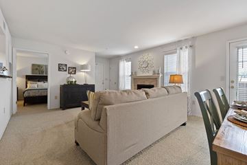 Oklahoma City apartment for rent - A living room with a beige couch and a fireplace.
