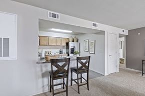 Lubbock apartment for rent - A kitchen area with a table and two chairs.