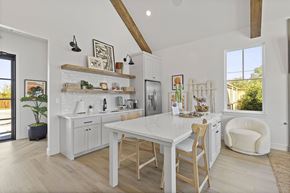 Oklahoma City triplex for rent - A white kitchen with wooden chairs and a table.