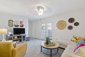 Norman apartment for rent - A living room with a yellow couch and a coffee table.