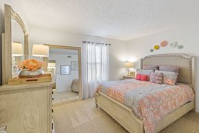 Norman apartment for rent - A bedroom with a large bed and a dresser with a mirror.