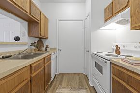 Ridgeland apartment for rent - A kitchen with wooden cabinets and a white oven.
