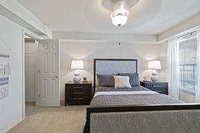 Waco apartment for rent - A bedroom with a large bed and two lamps.