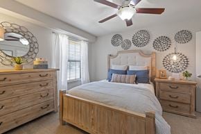 Temple apartment for rent - A bedroom with a bed, dresser, and mirror.