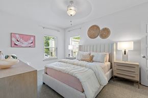 Independence townhouse for rent - a bedroom with a bed and a chair and a window