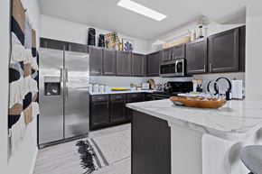 Kansas City apartment for rent - A kitchen with a white counter top and a refrigerator.