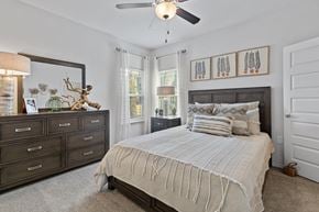 Kansas City apartment for rent - A bedroom with a large bed and a ceiling fan.