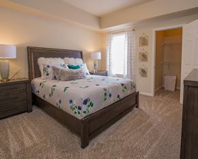 North Little Rock apartment for rent - A bedroom with a large bed and two lamps.