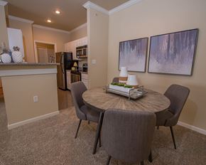 North Little Rock apartment for rent - A kitchen with a table and chairs in the foreground.