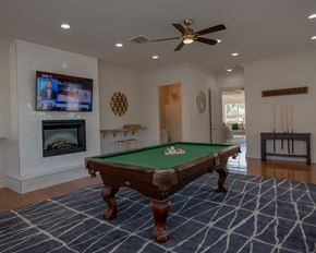 North Little Rock apartment for rent - A pool table in a room with a television and fireplace.