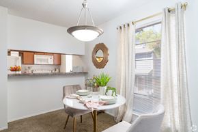 El Paso apartment for rent - A dining room with a table set for two and a potted plant on the table.