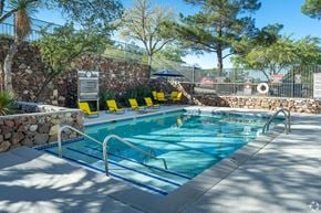 El Paso apartment for rent - A pool with a signboard and yellow sun loungers.
