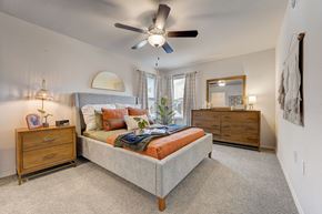 Yukon townhouse for rent - a bedroom with a bed and a ceiling fan