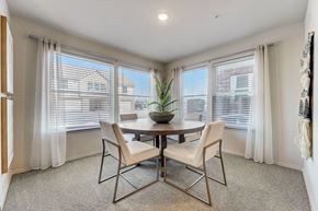 Yukon townhouse for rent - a dining room with windows and a table and chairs
