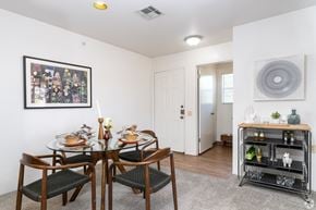 El Paso apartment for rent - A dining room with a table set for two and a painting on the wall.