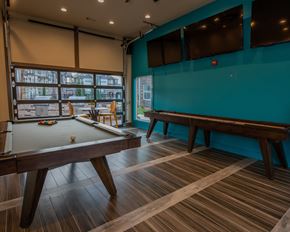 Oklahoma City apartment for rent - A pool table in a room with a blue wall.