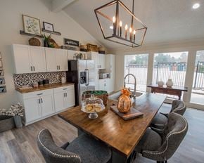 Oklahoma City apartment for rent - A dining room with a wooden table and chairs.