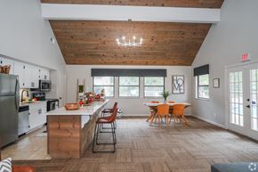 Ridgeland apartment for rent - A kitchen with a wooden ceiling and a dining table with chairs.