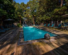 Ridgeland apartment for rent - A large stone ball sits on the edge of a blue pool.