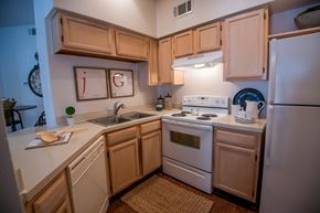 Ridgeland apartment for rent - A kitchen with wooden cabinets and white appliances.