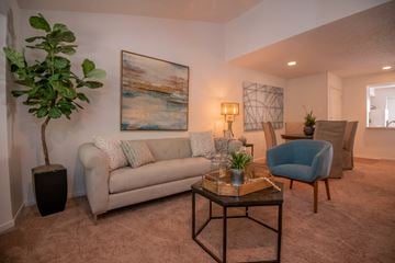 Ridgeland apartment for rent - A living room with a couch, chair, and a painting on the wall.