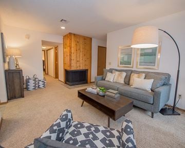 Oklahoma City apartment for rent - A living room with a grey couch and a wooden coffee table.