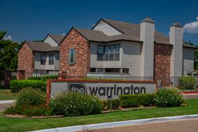 Oklahoma City apartment for rent - The Warrington sign is in front of a brick building.