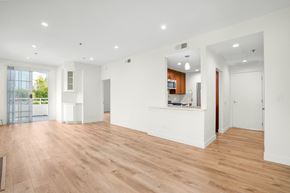 Los Angeles apartment for rent - Apartment living room built-in cabinets, balcony, and kitchen.