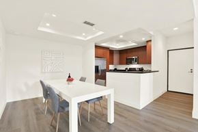Los Angeles apartment for rent - A modern dining room with a white table and grey chairs at Twelve One Ten Rochester, California