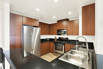Los Angeles apartment for rent - A modern kitchen with a stainless steel sink and refrigerator.