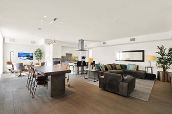 A modern living room with a dark wood floor and furniture