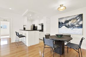 Los Angeles apartment for rent - A modern kitchen with a dining table and chairs at Wooster Encore Apartments, Los Angeles, CA