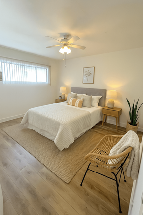 Los Angeles apartment for rent - A bedroom with a bed, chair, and ceiling fan.