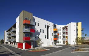 San Ysidro apartment for rent - A modern building with white, grey and red balconies.