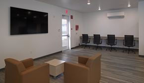 San Ysidro apartment for rent - A conference room with a large screen, chairs, and a table.