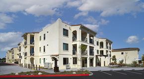 Buena Park apartment for rent - A white building with a red stripe in front.