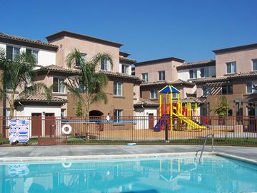 Montclair apartment for rent - a swimming pool in front of apartments with a playground