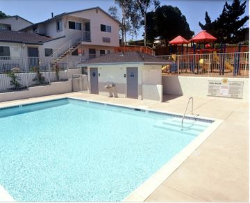National City apartment for rent - a swimming pool with a house in the background