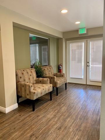Escondido apartment for rent - a living room with two chairs and a window and a door