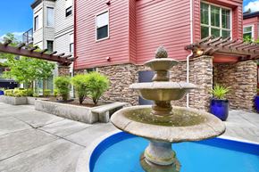 Redmond apartment for rent - A fountain in the middle of a pool surrounded by a house.