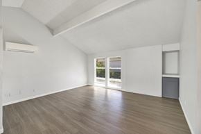 Kent apartment for rent - A spacious room with wooden flooring and a large window.