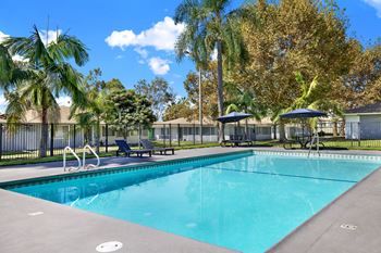 Sparkling swimming pool with lounge chairs