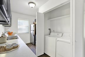 Kent apartment for rent - A small kitchen with a refrigerator, washer and dryer.